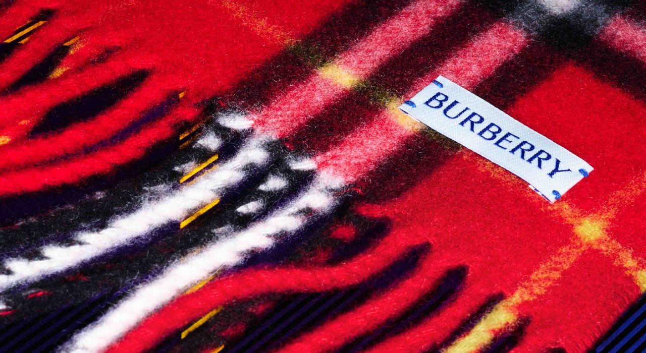 A close-up of a red Burberry check cashmere scarf, showcasing its soft texture.
