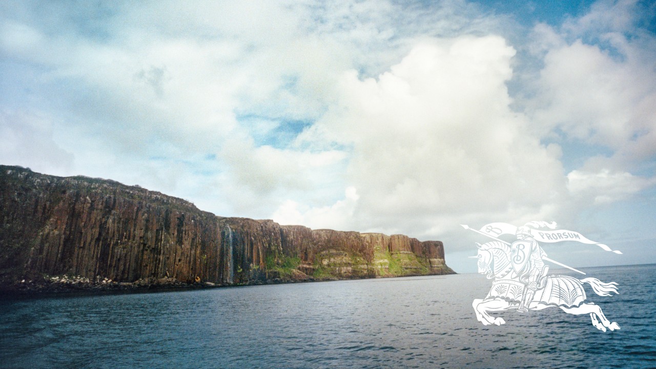 A scenic coastal landscape with high cliffs beside a calm sea, reflecting Burberry’s commitment to reducing environmental impacts, mitigating material risks, and supporting global efforts to address climate change and nature loss.