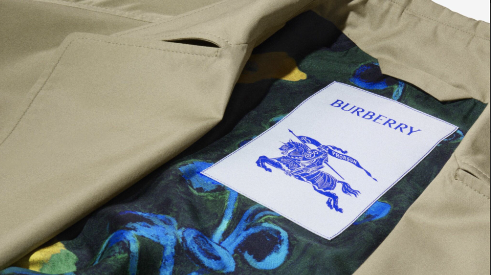 A close-up of the inside of a Burberry garment, showing a Burberry label and patterned lining, used to represent the brand’s Codes and Policies section.