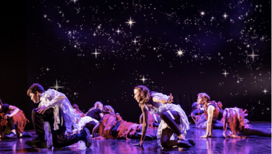 A group of young performers on stage under star-like lighting alongside an introduction to The Burberry Foundation, an independent charity focused on creativity, positive community impact, and building a sustainable future for young people.